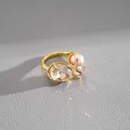 Detailed view of luxury gold open ring with faux pearl and oval faceted crystal - Gold Brown