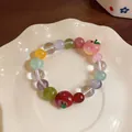 Close-up detail of a colorful beaded bracelet featuring red and peach apple charms - Fresh Beaded Apple Style (HB5940) / Colorful