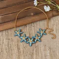 Detailed view of gold chain necklace featuring five blue enamel starfish pendants - Waist Chain-Gold / Blue