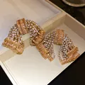 Statement gold bow earrings with sparkling zircon and rhinestones in jewelry box - Silver Post Bowknot (HE32637) / Gold-Champagne Zircon
