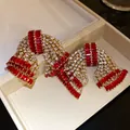 Exquisite oversized bow earrings featuring vibrant red and white cubic zirconia crystals - Silver Post Bowknot (HE32637) / Gold-Red Zirconia