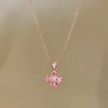 Detailed view of rose gold flower pendant necklace featuring sparkling pink teardrop stones - Rose Gold-Pink