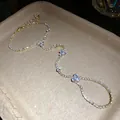 Close-up of a gold-plated rhinestone slave bracelet with elegant flower accents - Gold