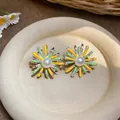 Macro view of colorful floral pearl stud earrings with vibrant yellow and green enamel - Hollow Bowknot Lace Style / Silver Post - Yellow - Green