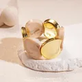 Close-up of acrylic and gold metal spliced elastic bracelet with marble pattern. - Gold-Beige