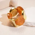 Detail view of retro acrylic and gold metal spliced elastic bracelet with amber finish. - Gold-Light Coffee