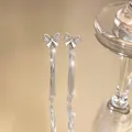 Elegant silver tassel earrings featuring a sparkling zircon-studded bow-knot design. - Silver Earring Post Style / Silver