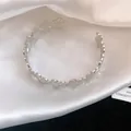 Detailed view of elegant silver vintage floral open cuff bracelet on smooth white silk fabric - Single Layer Flower Style / Silver