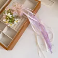 Detail of ballet style hair clip with pink organza flower and long colorful ribbons - Pink