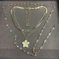 Elegant multi-layer gold metal necklace set featuring a white flower pendant and clear crystals - Set of Multi-piece (Transparent) / Gold