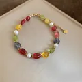 Detailed view of a colorful stone and pearl beaded bracelet with a gold chain finish. - Bracelet / Colorful