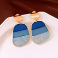 Dettaglio di orecchini vintage con pendente in acrilico blu a tre tonalità - Oro-Blu