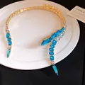 Detailed view of luxury gold-tone choker featuring vibrant blue and clear square crystals - Sapphire Blue / One Size