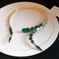 Detailed macro view of an emerald green square crystal choker in a vintage gold finish. - Emerald / One Size