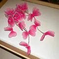 Close-up detail of pink silk mesh flower earrings featuring rhinestones and long tassels - Flower Tassel / Pink