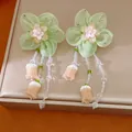Detailed view of handmade green chiffon flower earrings featuring elegant beaded tassels. - Green-Coffee (With Silver Post)