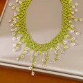 Detailed view of handcrafted green and pink floral beaded bohemian style necklace - Green-Pink