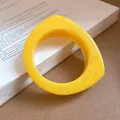 Detailed view of a geometric yellow resin bangle bracelet with unique marbled texture - Yellow