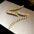 Detailed macro view of marquise-cut zirconia wheat ear pattern on golden bracelet - Wheat Ear Design / Gold