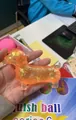 Glittery translucent orange dachshund squishy toy for sensory stress relief in hand - Dog Style / OPP Bag