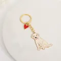 Close-up detail of a zinc alloy golden retriever dog keychain with red heart charm - Golden Retriever with Red Heart