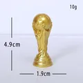 Miniature gold resin World Cup trophy replica ornament with size markings - World Cup Trophy