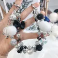 Handmade beaded phone chain with fuzzy pom-poms and crystal bow charm - Black and White Rhinestone Bow Pom Pom Style (A5-H)