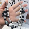 Luxury handmade beaded phone charm featuring elegant white pearls and black crystals - Chanel Bear Brand Logo Style (A5-K)