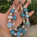 Handmade beaded phone charm with blue rhinestones and crown pendant in silver - Blue White Rhinestone Ball Crown Tassel Style (C2-O)