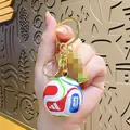 Detailed macro view of World Cup football keychain with golden trophy and logo - World Cup Lobster Clasp + Medium-sized World Cup Trophy