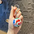 Detailed view of a creative soccer ball keychain with vibrant sports designs and metallic ring - World Cup Football Keychain