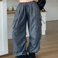 Detail of grey nylon parachute cargo pants with drawstring pockets and wide leg fit - S / Gray