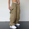 Detailed close-up of khaki nylon cargo parachute pants featuring a high waist and wide leg fit - S / Khaki