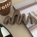 Close-up detail of a matte wavy hair claw clip in elegant coffee brown - Dark Coffee