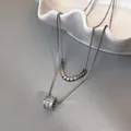 Zilveren dubbellaagse ketting met zirkoon-gezet cilinder hangertje en kraaltjes - Zilveren Zirconia Cilinder Dubbellaags Ketting