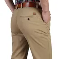 Close-up view of men's khaki straight-leg casual trousers featuring a leather pocket patch - 28 / Khaki