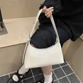 Glossy white minimalist underarm shoulder bag for women featuring a sleek modern design - White