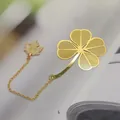 Elegant golden metal bookmark featuring a hollow four-leaf clover and maple leaf pendant - Four-Leaf Clover
