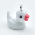 Detailed view of a white resin cartoon duck pendant with a metal loop for DIY accessories - White