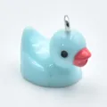 Macro view of a cute light blue resin duck charm for DIY jewelry and accessories - Blue