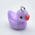 Detailed close-up view of a small purple resin cartoon duck charm for DIY jewelry making - Purple