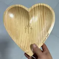 Close-up detail of a heart-shaped wooden prayer bowl featuring engraved crosses and text - 23*23*3cm / Clear Varnish