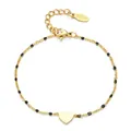 Elegante pulsera de corazón en acero inoxidable dorado con cuentas de esmalte negro. - Negro