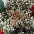 Close-up of a gold glittery hollow poinsettia flower for Christmas tree decoration - Rose Gold