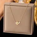 Elegant gold-toned necklace featuring a floral pendant and a single white pearl accent - Flower Clover Artificial Pearl Necklace (H367) / Gold