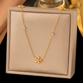 Elegant gold flower pendant necklace with cubic zirconia accents on a beige display box - Flower with White Rhinestone Style (H1197)