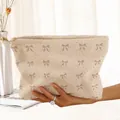 Macro view showing the soft texture of a cream corduroy makeup bag with bow print - Beige Pink Bow Polka Dot (EQ222581)