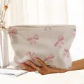 Detailed view of cream corduroy makeup bag with cute pink bow patterns and zipper - Beige Pink Bow Print (FN373909)