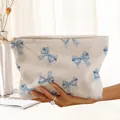 Detailed view of a soft white corduroy makeup pouch with light blue bow prints - Beige Blue Bow (PQ374618)