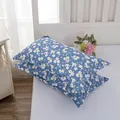 Close-up of a pair of blue floral pattern pillowcases featuring white and yellow flowers - Gypsophila Geometric